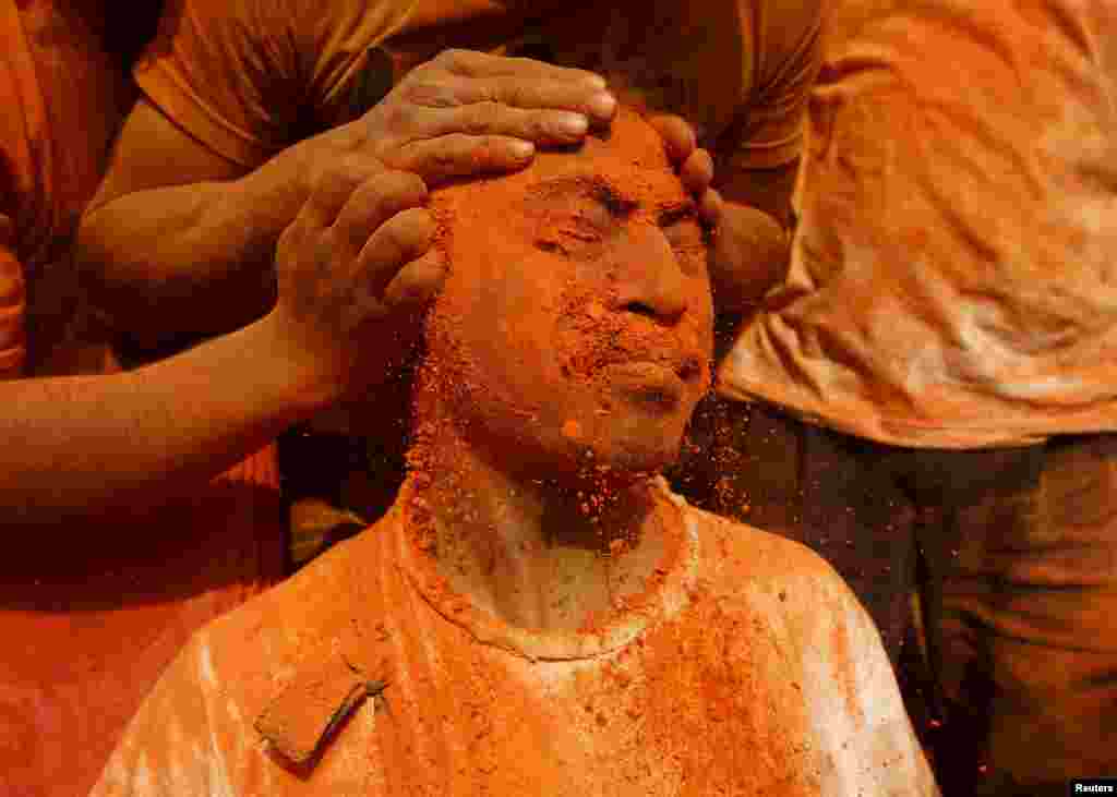 A devotee is smeared with a vermillion powder while celebrating the &quot;Sindoor Jatra&quot; vermillion powder festival at Thimi, in Bhaktapur, Nepal.