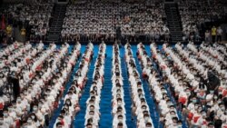 More than 7,000 students at the Huazhong University of Science and Technology attend a commencement ceremony in a gymnasium in Wuhan, in China's central Hubei province.