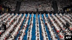 More than 7,000 students at the Huazhong University of Science and Technology attend a commencement ceremony in a gymnasium in Wuhan, in China's central Hubei province.