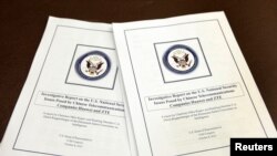 FILE - House Intelligence Committee's report on "national security threats posed by Chinese telecommunications companies Huawei and ZTE" is seen at a news conference on Capitol Hill in Washington.