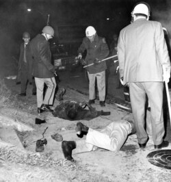 FILE - This file photo shows two black people killed in the "Orangeburg Massacre" at the edge of South Carolina State College in Orangeburg, South Carolina, Feb. 8, 1968.