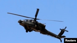 Egyptian soldiers and a military helicopter are seen deployed in the northeastern part of the Sinai Peninsula near the Rafah border crossing between Egypt and the Gaza Strip in this on May 21, 2013. file photo.