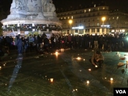 People return to the Place de la Republique in Paris square in Paris, France after panic spread about another possible attack, Nov. 15, 2015. (Photo: D. Schearf / VOA)