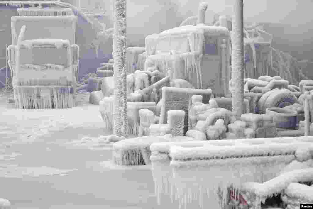 Ice-covered trucks are blanketed in smoke after a warehouse fire in Chicago, Illinois, USA. Fire department officials said it is the biggest fire the department has had to battle in years and one-third of all Chicago firefighters were on the scene at one point or another trying to put out the flames.