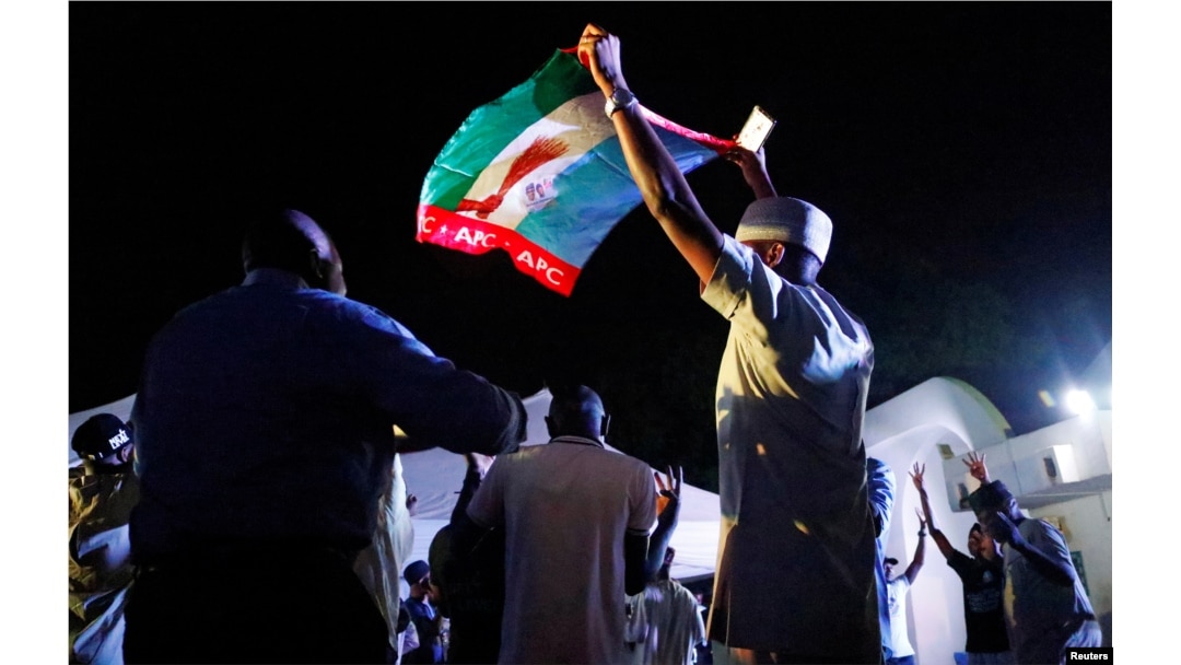Supporters of Nigeria's President Muhammadu Buhari celebrate at the campaign headquarters of the All Progressives Congress (APC) party in Abuja, Nigeria, Feb. 26, 2019.