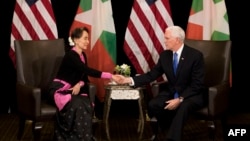 US Vice President Mike Pence (R) shakes hands with Myanmar State Counsellor Aung San Suu Kyi during a bilateral meeting on the sidelines of the 33rd Association of Southeast Asian Nations (ASEAN) summit in Singapore on November 14, 2018. (Photo by Bernat Armangue / POOL / AFP)