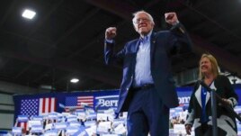 Democratic presidential candidate Sen. Bernie Sanders, I-Vt., accompanied by his wife Jane O'Meara Sanders, arrives to speak during a primary night election rally in Essex Junction, Vt., Tuesday, March 3, 2020. (AP Photo/Matt Rourke)