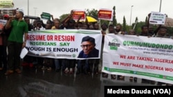 FILE - Protesters take to the streets in Nigeria, demanding that President Muhammadu Buhari either get back to work or step down.