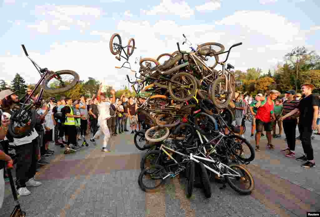 Bicycle riders place their bikes in a pile after a mass ride in Almaty, Kazakhstan.