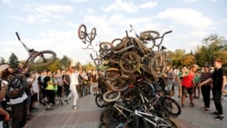 Bicycle riders place their bikes in a heap after a mass ride in Almaty, Kazakhstan.