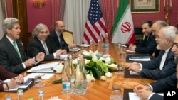 U.S. Secretary of State John Kerry, left, holds a meeting with Iran's Foreign Minister Mohammad Javad Zarif, right, over Iran's nuclear program in Lausanne, Switzerland, Tuesday, March 17, 2015.