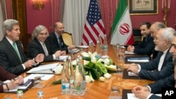 FILE - U.S. Secretary of State John Kerry, left, holds a meeting with Iran's Foreign Minister Mohammad Javad Zarif, right, over Iran's nuclear program in Lausanne, Switzerland, March 17, 2015.
