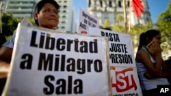 A woman holds a banner that reads in Spanish "Free Milagro Sala" during a demonstration in support of Argentina's Tupac Amaru social movement leader Milagro Sala, in Buenos Aires, Argentina, Jan. 27, 2016.