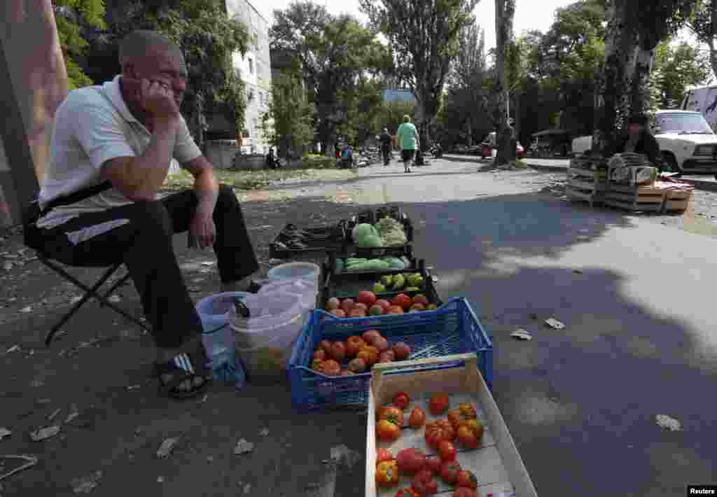 A man sells vegetables in Donetsk, Aug. 12, 2014.
