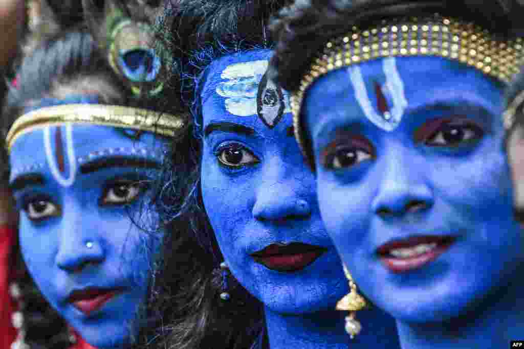Students dressed up as Hindu gods Lord Krishna and Lord Shiva participate in a cultural event in their school in Mumbai, India.