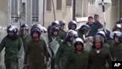 An image grab taken from AFP TV shows Syrian security forces walking towards anti-regime protesters as they attempt to reach the main square in the flashpoint city of Homs on January 1, 2012.