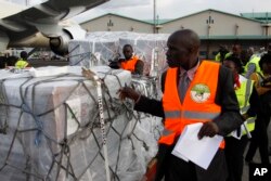 Independent Electoral and Boundaries Commission IEBC officials receive ballot papers for the repeat of the presidential election on Oct. 26, at JKIA airport in Nairobi, Kenya, Oct. 23, 2017.