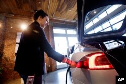 FILE - An electric car is seen at a dealership in Seattle, Feb. 4, 2015.