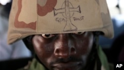 A soldier looks out from under the brim of his helmet in Maiduguri, Nigeria, June 6, 2013.
