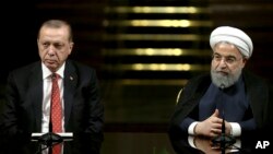 Iranian President Hassan Rouhani, right, speaks to the media during a joint press conference with Turkish President Recep Tayyip Erdogan after their meeting at the Saadabad Palace in Tehran, Iran, Oct. 4, 2017