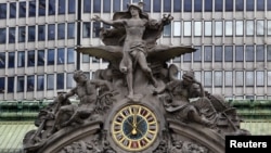 The clock on the south facing side of New York's Grand Central Terminal strikes noon March 29, 2012.