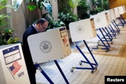 A man fills out a ballot at the Central Synagogue as polling stations open for the New York state primary elections in the Manhattan borough of New York, April 19, 2016.