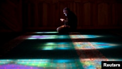 A Crimean Tatar man prays at a mosque in Bakhchysarai, Ukraine, March 10, 2014.