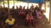 Children learn while sitting in sand in a makeshift school at the Chingwizi transit camp, February 2016. (S. Mohfu/VOA)