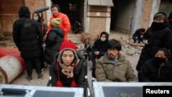 Director Shen Chenyan (second from right) and executive producer Liu Menghuan (left) watch a scene of their post-apocalyptic movie on the set in Langfang, Hebei province, China, Dec. 16, 2016.