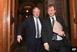 Britain's Foreign Secretary Boris Johnson, left, walks with Richard Ratcliffe, the husband of British-Iranian Nazanin Zaghari-Ratcliffe, at the Foreign & Commonwealth Office in London, Nov. 15, 2017.