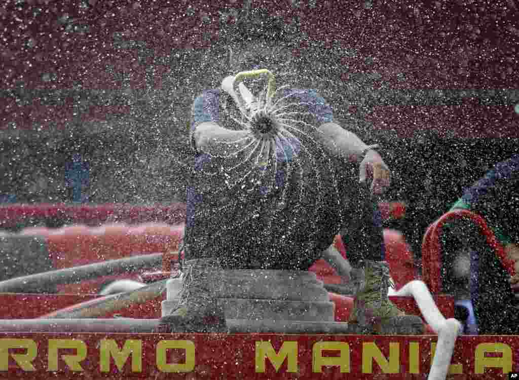 Firemen spray disinfectants outside a public market in Manila, the Philippines.