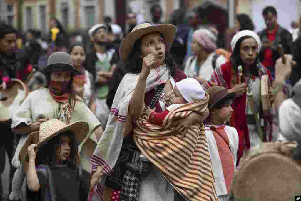 A woman marches with her children in an anti-government demonstration in Bogota, Colombia.