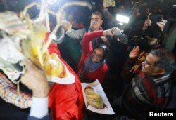 Protesters beat an effigy of Pinarayi Vijayan, Chief Minister of the southern state of Kerala, during a protest against state government for allowing two women to enter the Sabarimala temple, in New Delhi, India, Jan. 3, 2018.