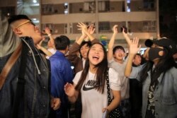 Pro-democracy supporters celebrate after pro-Beijing politician Junius Ho lost his election in Hong Kong, early Monday, Nov. 25, 2019.