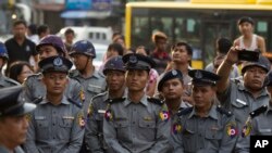 FILE - Riot police stand in position to block activists during a rally for peace, May 12, 2018, in Yangon, Myanmar.