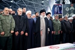 Iran's Supreme Leader Ayatollah Ali Khamenei and Iranian President Hassan Rouhani pray near the coffin of Iranian Major-General Qassem Soleimani, head of the elite Quds Force, who was killed in an air strike at Baghdad airport, in Tehran, Iran,