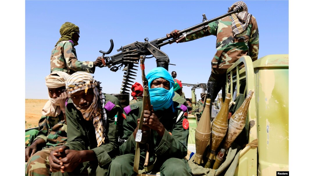 FILE - Military personnel patrol in Tabit village in North Darfur, Nov. 20, 2014, as region's joint peacekeeping mission, UNAMID, continues to seek access to Tabit since earlier this month to investigate media reports of an alleged mass rape of women and