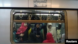 Commuters are seen inside the metro at Sadat metro station underneath Tahrir Square in Cairo, Egypt, June 17, 2015.
