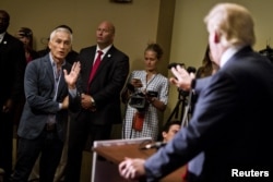 FILE - Republican presidential candidate Donald Trump spars with Univision reporter Jorge Ramos before his "Make America Great Again Rally" at the Grand River Center in Dubuque, Iowa, Aug. 25, 2015.