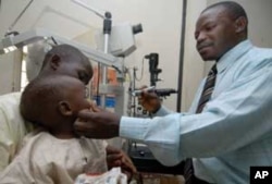 Mr Jaiye an ophthalmologic nurse of the Ministry of Health, in Lokoja, Kogi State examining a patient during community eye screening