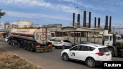 A United Nations vehicle follows a fuel tanker as it arrives at the Gaza power plant, in the central Gaza Strip, Oct. 9, 2018. 