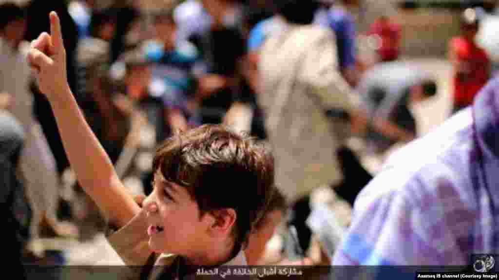 A young boy being trained in an Islamic State-run school volunteers for a suicide bombing. Source: Aaamaq IS channel