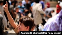 A young boy being trained in an Islamic State-run school volunteers for a suicide bombing. Source: Aaamaq IS channel