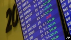 FILE - A cancelled flight to Egypt's Sharm el-Sheikh is displayed on an airport departure information board.