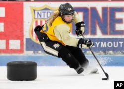 In this March 28, 2017, photo, Crosby Wildfong, 12, skates during practice with the HoneyBaked 12U Tier 1 hockey team, in Farmington Hills, Mich.