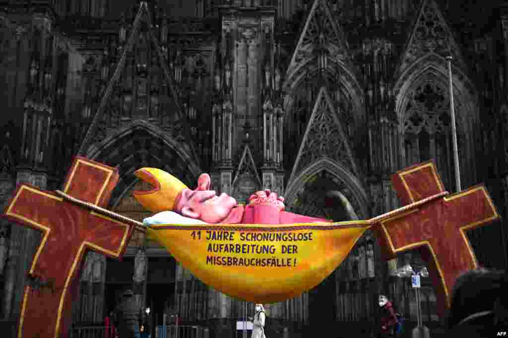 A sculpture by artist Jacques Tilly with the words '11 years of relentless investigation of the abuse cases!' is seen in front of the Cologne Cathedral in Cologne, Germany, as a long-awaited report was published on alleged sexual violence in Germany's top diocese.