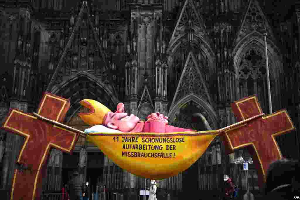 A sculpture by artist Jacques Tilly with the slogan &#39;11 years of relentless investigation of the abuse cases!&#39; is seen in front of the Cologne Cathedral in Cologne, Germany, as a long-awaited report was published on alleged sexual violence in Germany&#39;s to