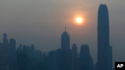 FILE - The skyline of Hong Kong's business district at sunset.