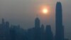 FILE - The skyline of the business district is silhouetted at sunset in Hong Kong.