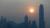 FILE - The skyline of the business district is silhouetted at sunset in Hong Kong.